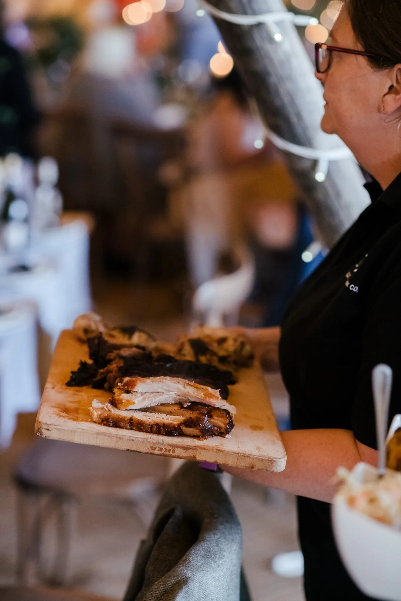 BBQ feast board served at a Yorkshire tipi wedding with fairy lights