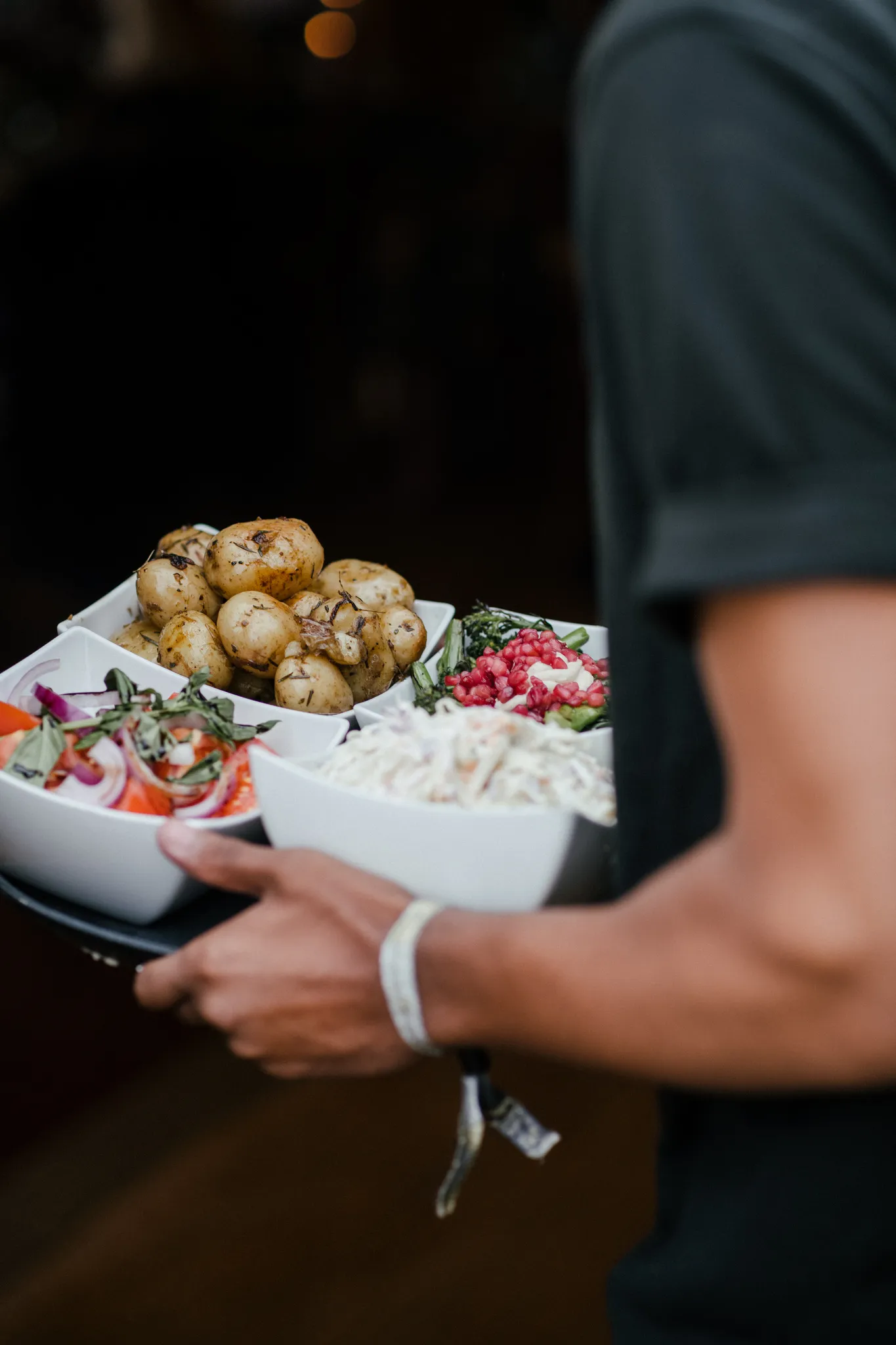 Chef carrying sharing sides bowls at a Yorkshire wedding
