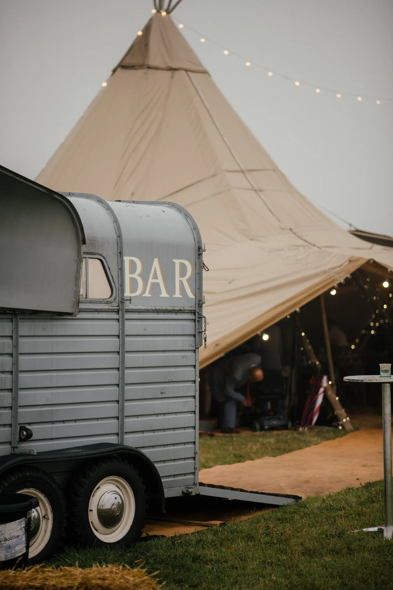 Vintage horsebox bar exterior beside a Yorkshire wedding tipi
