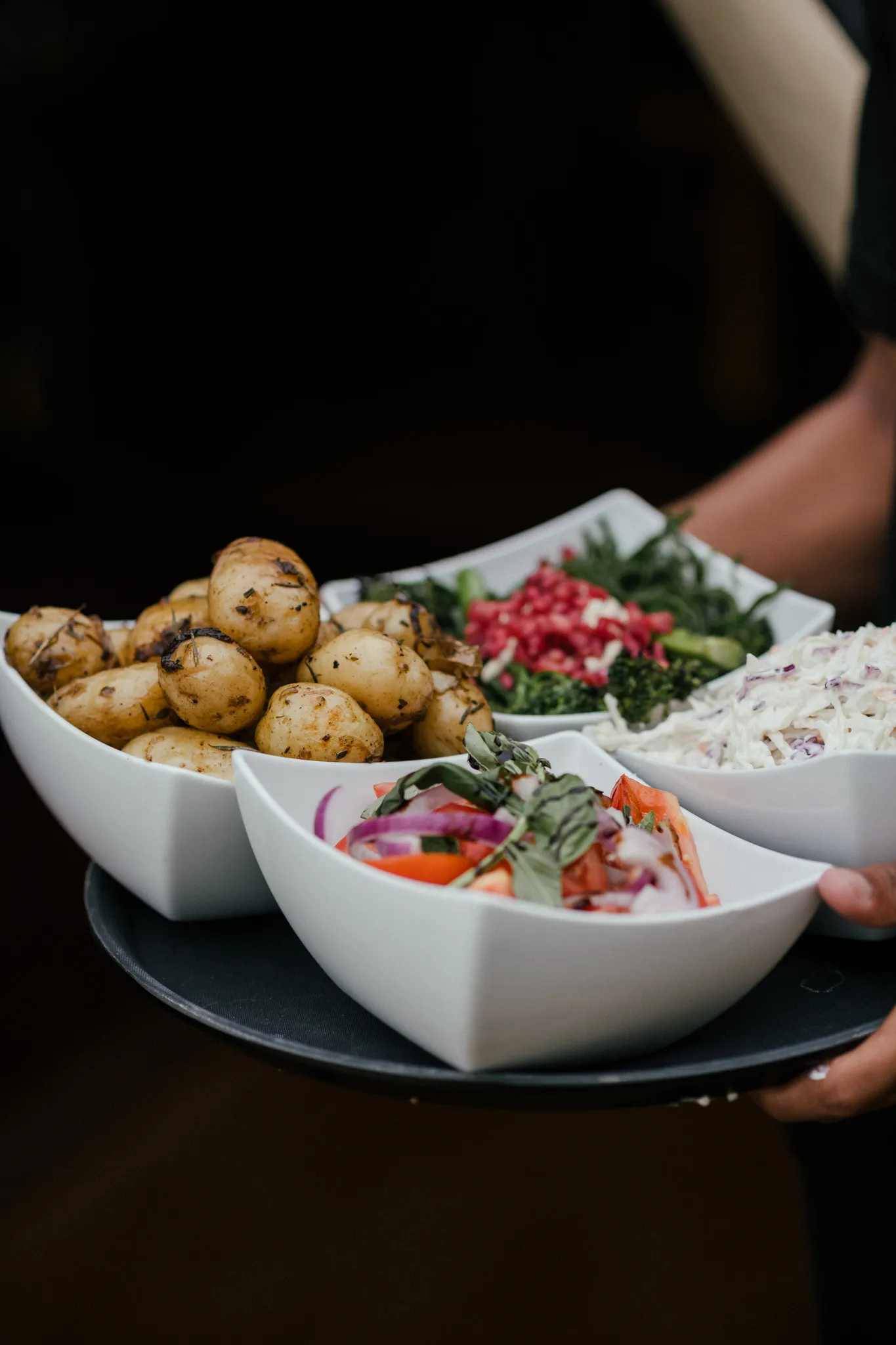 Sharing sides — roasted potatoes, tabbouleh and coleslaw — at a Yorkshire wedding