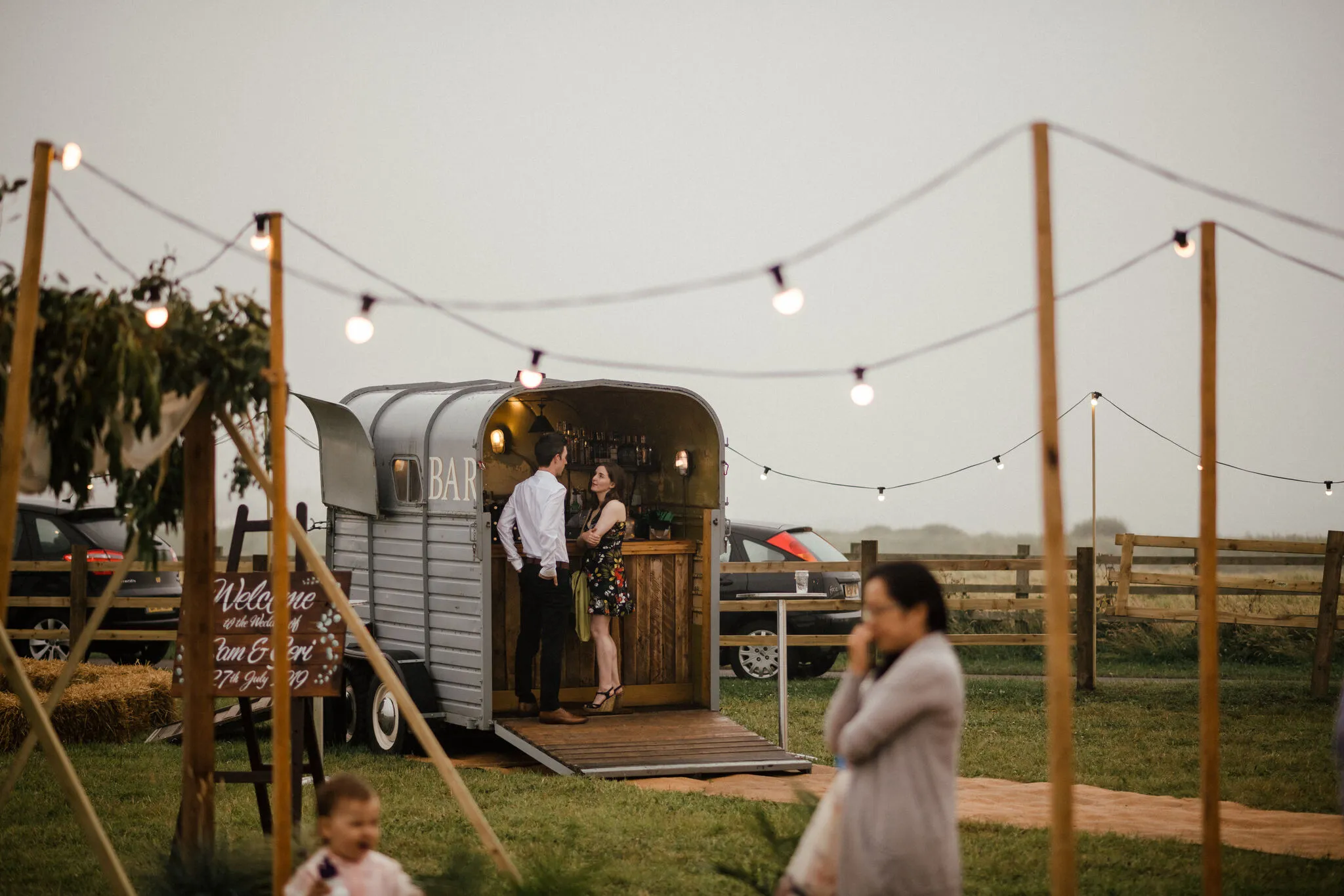 Couple at the horsebox bar at dusk at a Yorkshire wedding